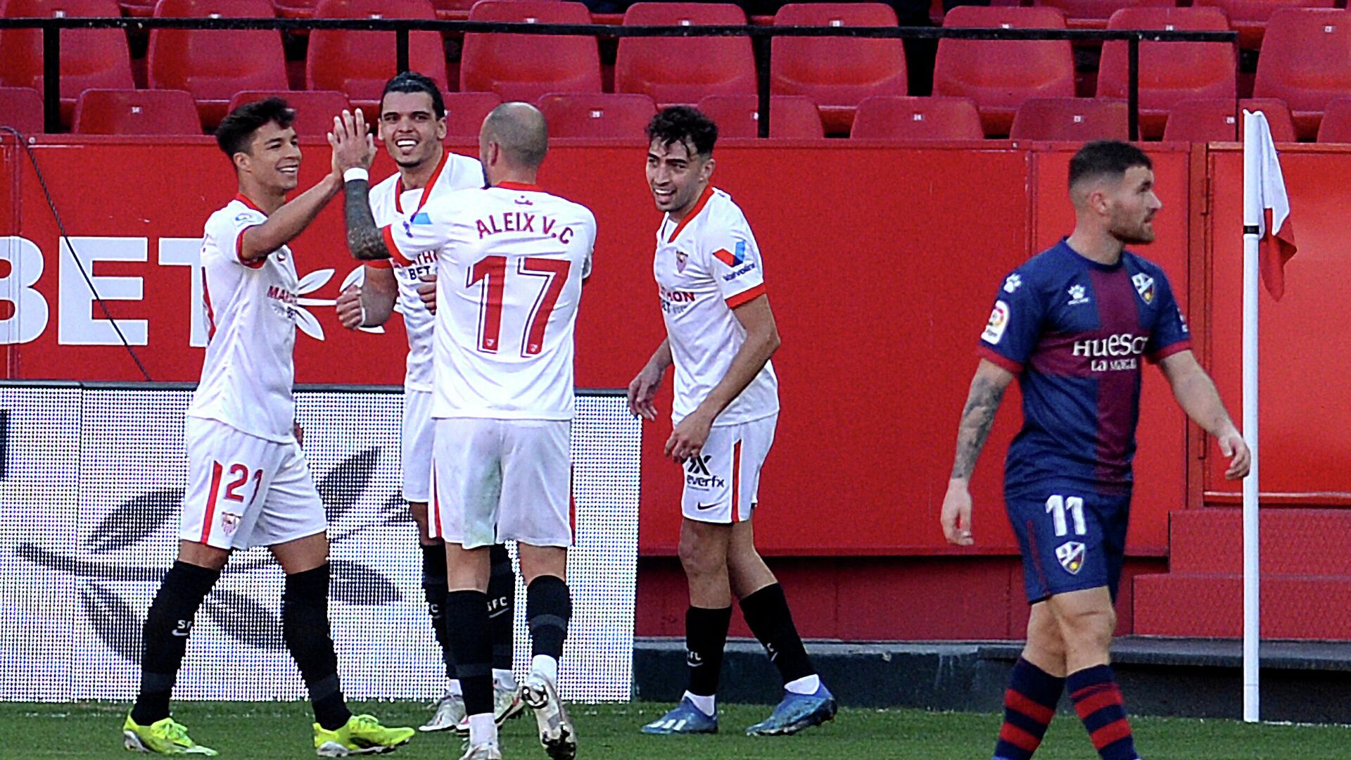 Sevilla players celebrate their goal scored by forward Munir El Haddadi (2R) during the Spanish league football match between Sevilla FC and SD Huesca at the Ramon Sanchez Pizjuan stadium in Seville on February 13, 2021. (Photo by CRISTINA QUICLER / AFP) - РИА Новости, 1920, 13.02.2021