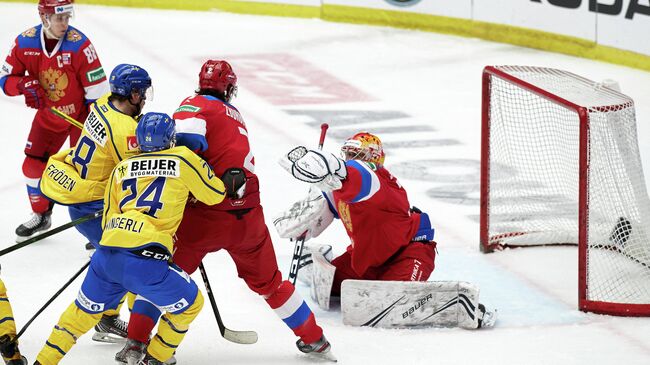 Russia's goalkeeper Alexander Samonov (R) makes a save during the Beijer Hockey Games (Euro Hockey Tour) ice hockey match between Sweden and Russia in Malmo on February 13, 2021. (Photo by Anders Bjuro / TT NEWS AGENCY / AFP) / Sweden OUT