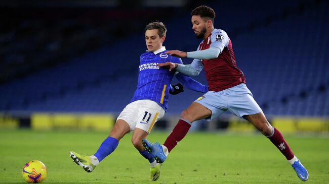 Aston Villa's Brazilian midfielder Douglas Luiz (R) pressures Brighton's Belgian midfielder Leandro Trossard (L) during the English Premier League football match between Brighton and Hove Albion and Aston Villa at the American Express Community Stadium in Brighton, southern England on February 13, 2021. (Photo by ANDREW COULDRIDGE / POOL / AFP) / RESTRICTED TO EDITORIAL USE. No use with unauthorized audio, video, data, fixture lists, club/league logos or 'live' services. Online in-match use limited to 120 images. An additional 40 images may be used in extra time. No video emulation. Social media in-match use limited to 120 images. An additional 40 images may be used in extra time. No use in betting publications, games or single club/league/player publications. / 