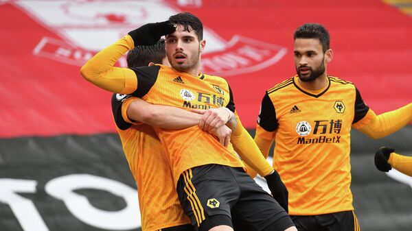Wolverhampton Wanderers' Portuguese midfielder Pedro Neto (C) celebrates with teammates after scoring their second goal during the English Premier League football match between Southampton and Wolverhampton Wanderers at St Mary's Stadium in Southampton, southern England on February 14, 2021. (Photo by Andy Rain / POOL / AFP) / RESTRICTED TO EDITORIAL USE. No use with unauthorized audio, video, data, fixture lists, club/league logos or 'live' services. Online in-match use limited to 120 images. An additional 40 images may be used in extra time. No video emulation. Social media in-match use limited to 120 images. An additional 40 images may be used in extra time. No use in betting publications, games or single club/league/player publications. / 