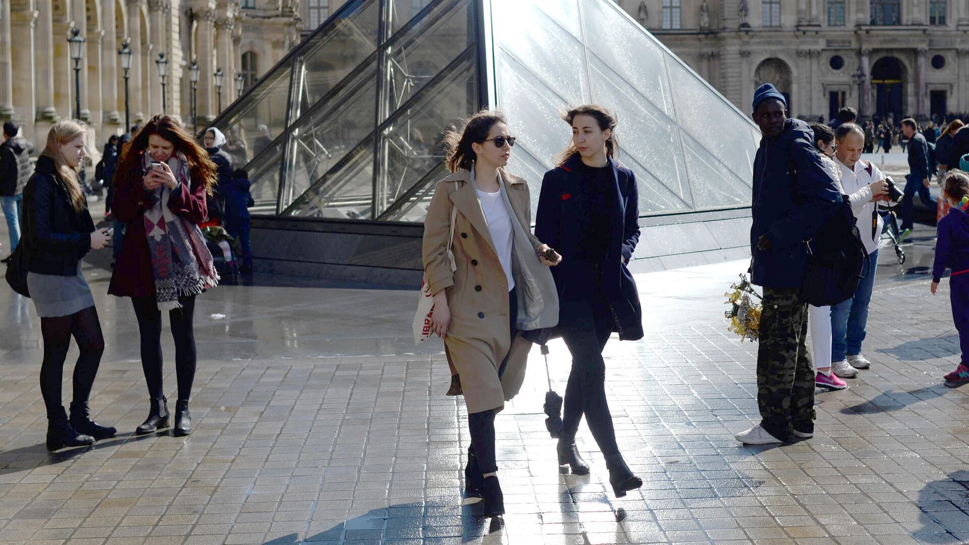 Девушки у стеклянной пирамиды Лувра во дворе Наполеона в Париже - РИА Новости, 1920, 15.01.2024