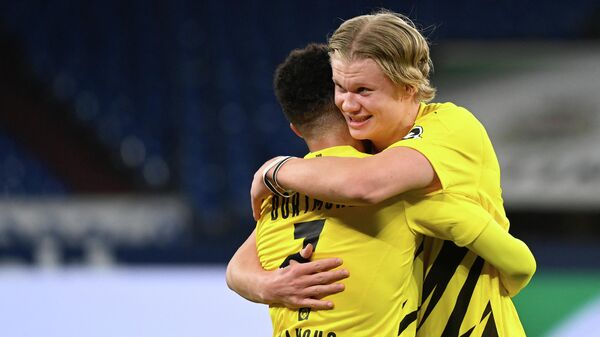 Dortmund's Norwegian forward Erling Braut Haaland (R) celebrates with Dortmund's English midfielder Jude Bellingham after the German first division Bundesliga football match FC Schalke 04 vs Borussia Dortmund in Gelsenkirchen, western Germany, on February 20, 2021. - Dortmund won the match 4-0. (Photo by Ina Fassbender / various sources / AFP) / RESTRICTIONS: DFL REGULATIONS PROHIBIT ANY USE OF PHOTOGRAPHS AS IMAGE SEQUENCES AND/OR QUASI-VIDEO