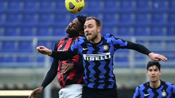 AC Milan's Portuguese forward Rafael Leao (L) and Inter Milan's Danish midfielder Christian Eriksen go for a header during the Italian Serie A football match AC Milan vs Inter Milan on February 21, 2021 at the San Siro stadium in Milan. (Photo by MIGUEL MEDINA / AFP)
