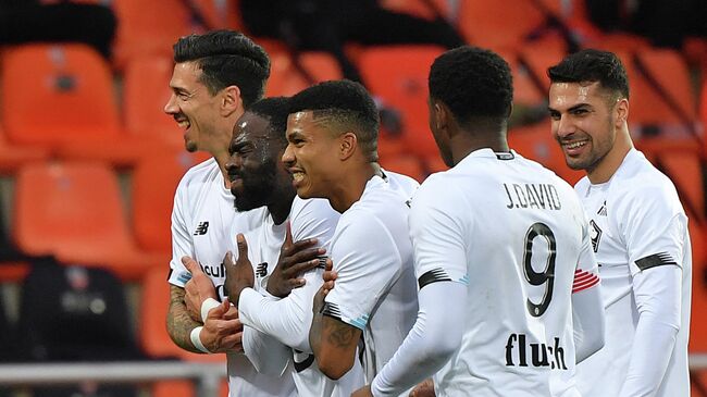 Lille's French midfielder Jonathan Ikone (2ndL) celebrates after scoring during the French L1 football match between FC Lorient and Lille at the Moustoir Stadium in Lorient, western France, on February 21, 2021. (Photo by LOIC VENANCE / AFP)