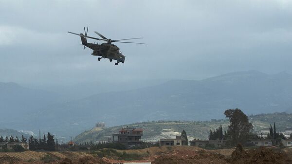 Российский вертолет совершает полет у авиабазы Хмеймим в Сирии