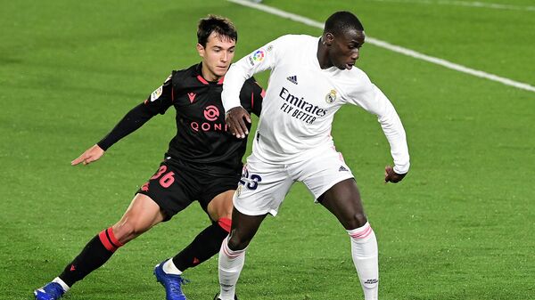 Real Sociedad's Spanish midfielder Martin Zubimendi (L) challenges Real Madrid's French defender Ferland Mendy during the Spanish league football match between Real Madrid CF and Real Sociedad at the Alfredo di Stefano stadium in Valdebebas, on the outskirts of Madrid on March 1, 2021. (Photo by JAVIER SORIANO / AFP)