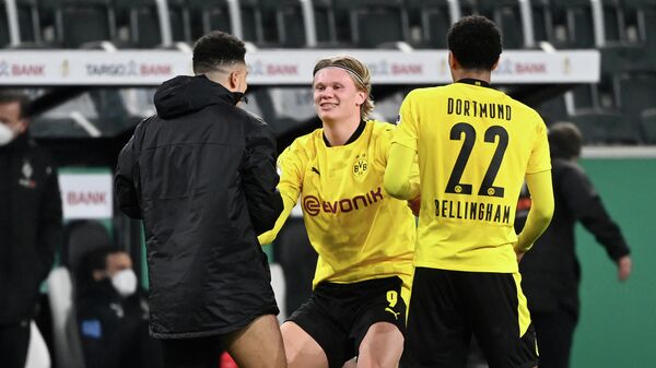 (LtoR) Dortmund's English midfielder Jadon Sancho, Dortmund's Norwegian forward Erling Braut Haaland and Dortmund's English midfielder Jude Bellingham celebrate after the German Cup (DFB Pokal) quarter-final football match between Borussia Moenchengladbach and Borussia Dortmund in Moenchengladbach, western Germany, on March 2, 2021. - Dortmund won the match 1-0 and qualified for the semi-finals. (Photo by Ina Fassbender / various sources / AFP) / DFB REGULATIONS PROHIBIT ANY USE OF PHOTOGRAPHS AS IMAGE SEQUENCES AND QUASI-VIDEO.