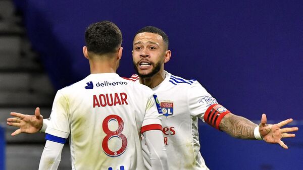 Lyon's French midfielder Houssem Aouar (L) celebrates with Lyon's Dutch forward Memphis Depay after scoring during the French L1 football match between Olympique Lyonnais and Stade Rennais Football Club at the Groupama Stadium in Decines-Charpieu, near Lyon, central-eastern France on March 3, 2021. (Photo by PHILIPPE DESMAZES / AFP)