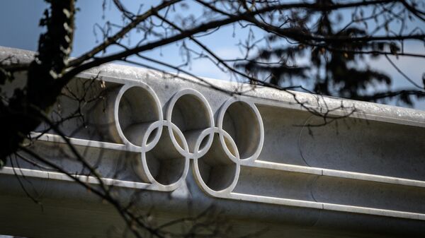 A picture taken on March 8, 2021 in Lausanne shows the Olympic rings next to the headquarters of the International Olympic Committee (IOC) ahead of a session of the World's sport governing body held virtually. (Photo by Fabrice COFFRINI / AFP)
