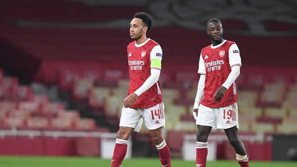Arsenal's Gabonese striker Pierre-Emerick Aubameyang (L) and Arsenal's French-born Ivorian midfielder Nicolas Pepe react at the final whistle during the UEFA Europa League Round of 16, 2nd leg football match between Arsenal and Olympiakos at the Emirates Stadium in London on March 18, 2021. (Photo by DANIEL LEAL-OLIVAS / AFP)