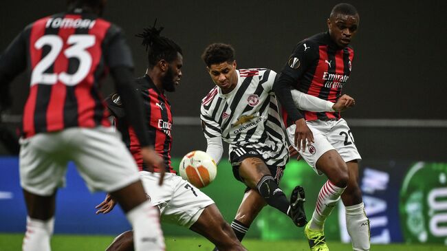 Manchester United's England's forward Marcus Rashford (C) challenges AC Milan's Ivorian midfielder Franck Kessie (Rear L) and AC Milan's French defender Pierre Kalulu during the UEFA Europa League round of 16 second leg football match between AC Milan and Manchester United at San Siro stadium in Milan on March 18, 2021. (Photo by Marco BERTORELLO / AFP)