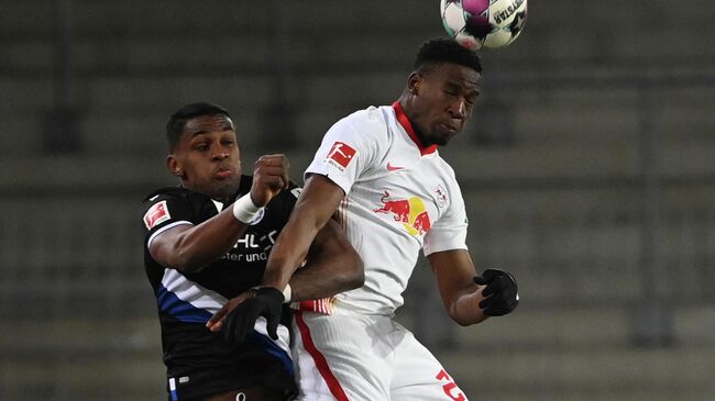 Bielefeld's Venezuelan forward Sergio Cordova and Leipzig's French defender Nordi Mukiele vie for the ball during the German first division Bundesliga football match Arminia Bielefeld v RB Leipzig  in Bielefeld, northern Germany, on March 19, 2021. (Photo by Ina Fassbender / various sources / AFP) / DFL REGULATIONS PROHIBIT ANY USE OF PHOTOGRAPHS AS IMAGE SEQUENCES AND/OR QUASI-VIDEO