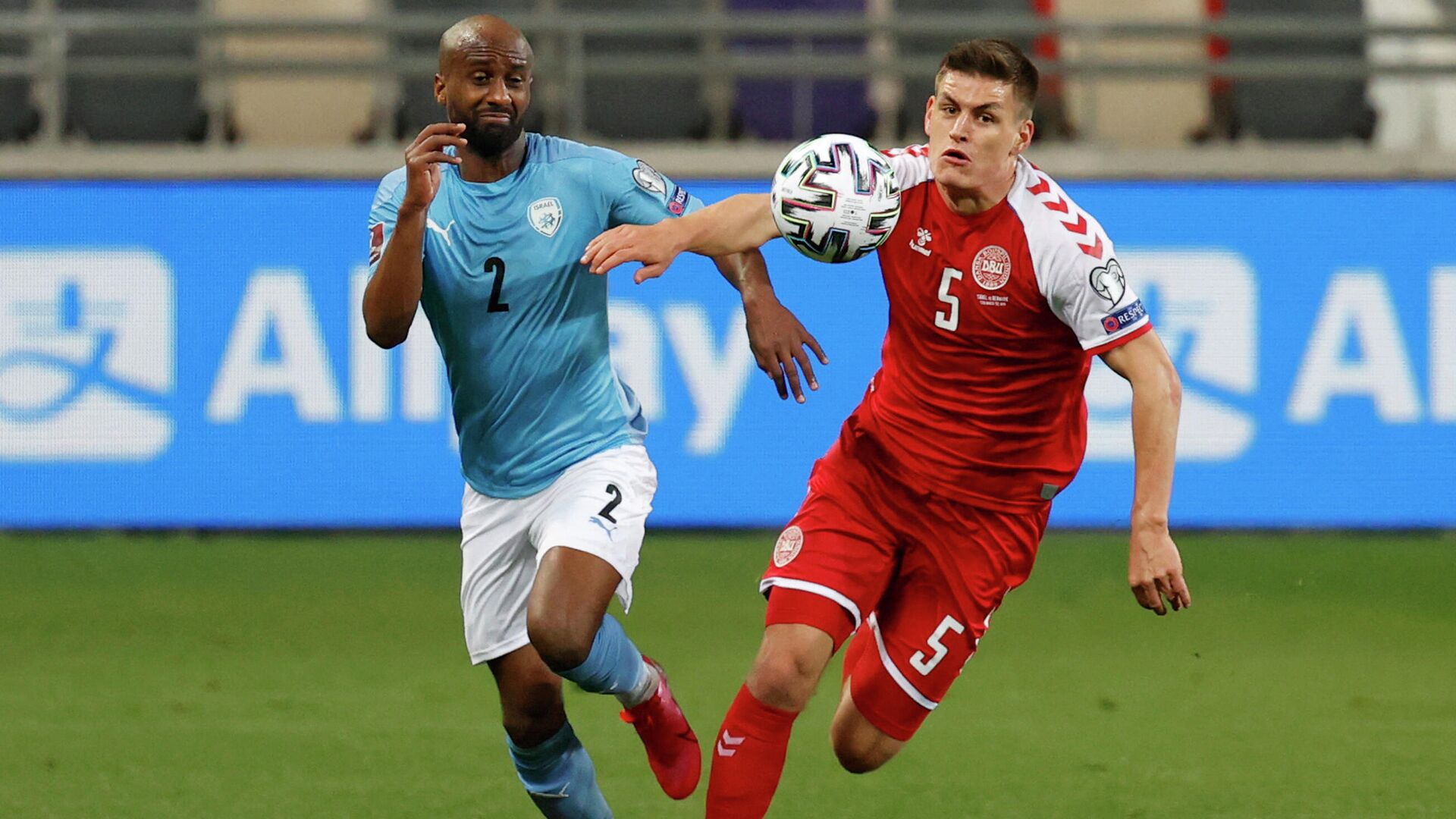 Denmark's defender Joakim Maehle (R) vies for the ball with Israel's defender Eli Dasa during the 2022 FIFA World Cup qualifier group F football match between Israel and Denmark at Bloomfield stadium in the Israeli Mediterranean coastal city of Tel Aviv on March 25, 2021. (Photo by JACK GUEZ / AFP) - РИА Новости, 1920, 25.03.2021