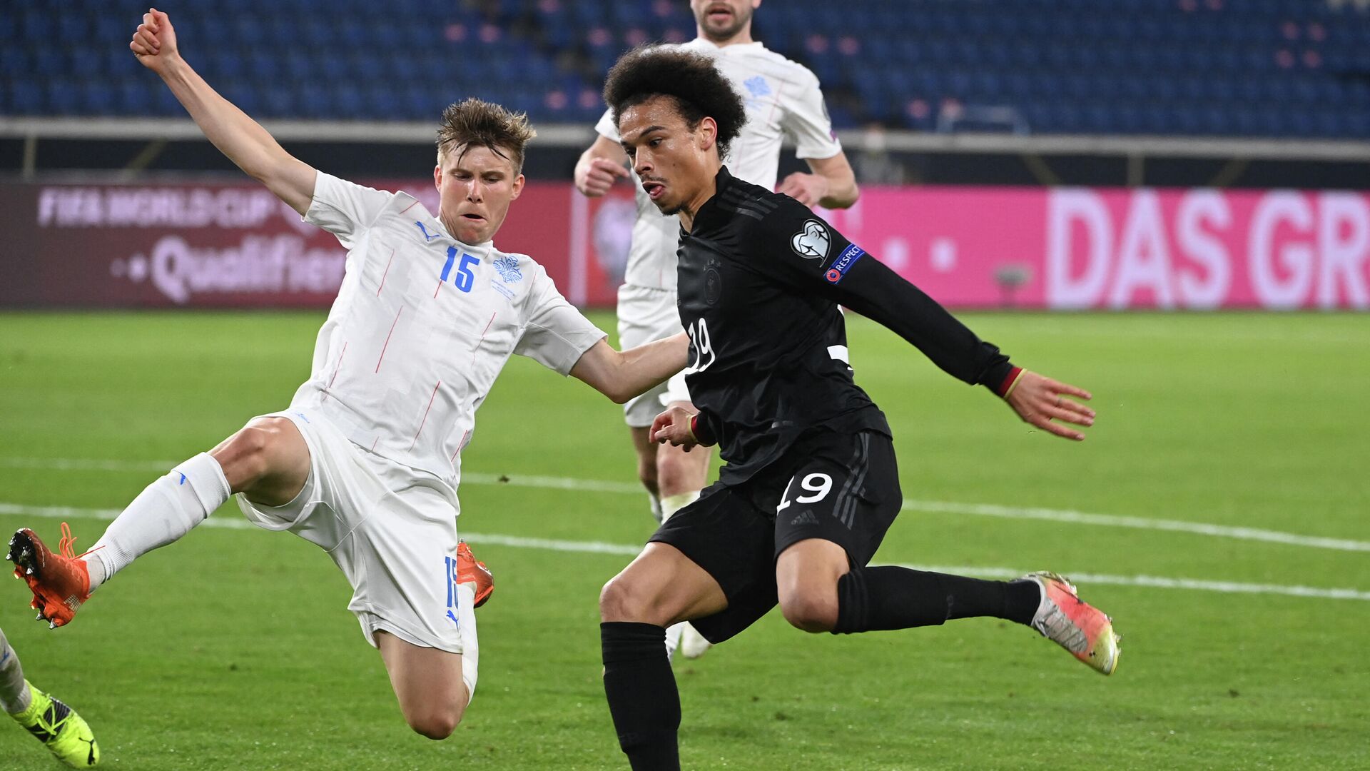 Iceland's defender Alfons Sampsted and Germany's midfielder Leroy Sane (R) vie for the ball during the FIFA World Cup Qatar 2022 qualification football match Germany v Iceland in Duisburg, western Germany on March 25, 2021. (Photo by Ina Fassbender / AFP) - РИА Новости, 1920, 26.03.2021