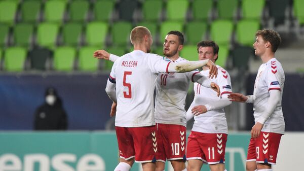 Denmark's players celebrate their victory over France during the UEFA Under21 Championship group stage football match France v Denmark in Szombathely on March 25, 2021. (Photo by Attila KISBENEDEK / AFP)