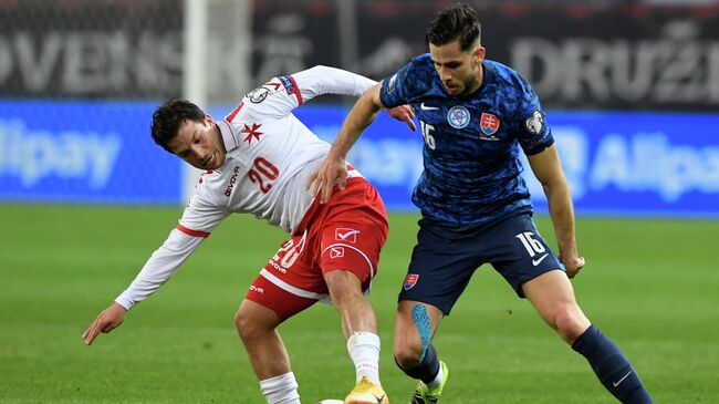 Slovakia's defender David Hancko (R) and Malta's forward Luke Gambin vie for the ball during the FIFA World Cup Qatar 2022 qualification football match Slovakia vs Malta in Trnava on March 27, 2021. (Photo by Stringer / AFP)