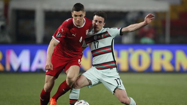 Serbia's defender Nikola Milenkovic (L) fights for the ball with Portugal's forward Diogo Jota during the FIFA World Cup Qatar 2022 qualification Group A football match between Serbia and Portugal at the Rajko Mitic Stadium, in Belgrade, on March 27, 2021. (Photo by pedja milosavljevic / AFP)