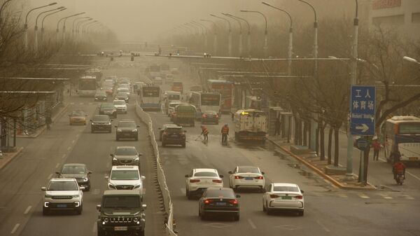 Автомобильное движение на одной из улиц Пекина после песчаной бури