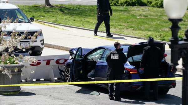 Офицеры полиции Капитолия США возле автомобиля, который врезался в заграждение на Капитолийском холме в Вашингтоне