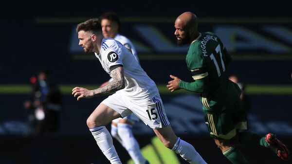 Leeds United's Northern Irish midfielder Stuart Dallas (L) runs with the ball during the English Premier League football match between Leeds United and Sheffield United at Elland Road in Leeds, northern England on April 3, 2021. (Photo by Lindsey Parnaby / POOL / AFP) / RESTRICTED TO EDITORIAL USE. No use with unauthorized audio, video, data, fixture lists, club/league logos or 'live' services. Online in-match use limited to 120 images. An additional 40 images may be used in extra time. No video emulation. Social media in-match use limited to 120 images. An additional 40 images may be used in extra time. No use in betting publications, games or single club/league/player publications. / 