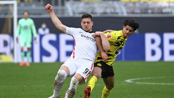 Frankfurt's Serbian forward Luka Jovic (L) and Dortmund's German midfielder Mahmoud Dahoud vie for the ball during the German first division Bundesliga football match between Borussia Dortmund and Eintracht Frankfurt in Dortmund, western Germany, on April 3, 2021. (Photo by Ina Fassbender / POOL / AFP) / DFL REGULATIONS PROHIBIT ANY USE OF PHOTOGRAPHS AS IMAGE SEQUENCES AND/OR QUASI-VIDEO