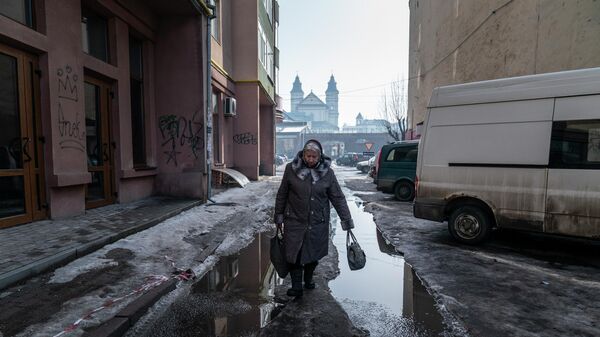 Женщина идет по улице в Ивано-Франковске, Украина 