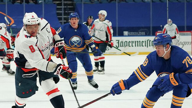 BUFFALO, NY - APRIL 9: Alex Ovechkin #8 of the Washington Capitals takes a shot as Jacob Bryson #78 of the Buffalo Sabres defends during the first period at KeyBank Center on April 9, 2021 in Buffalo, New York.   Kevin Hoffman/Getty Images/AFP (Photo by Kevin Hoffman / GETTY IMAGES NORTH AMERICA / Getty Images via AFP)