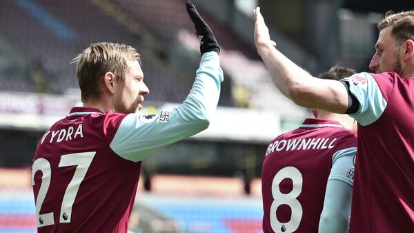 Burnley's Czech striker Matej Vydra (L) celebrates after scoring the first goal  during the English Premier League football match between Burnley and Newcastle United at Turf Moor in Burnley, north west England on April 11, 2021. (Photo by PETER POWELL / POOL / AFP) / RESTRICTED TO EDITORIAL USE. No use with unauthorized audio, video, data, fixture lists, club/league logos or 'live' services. Online in-match use limited to 120 images. An additional 40 images may be used in extra time. No video emulation. Social media in-match use limited to 120 images. An additional 40 images may be used in extra time. No use in betting publications, games or single club/league/player publications. / 