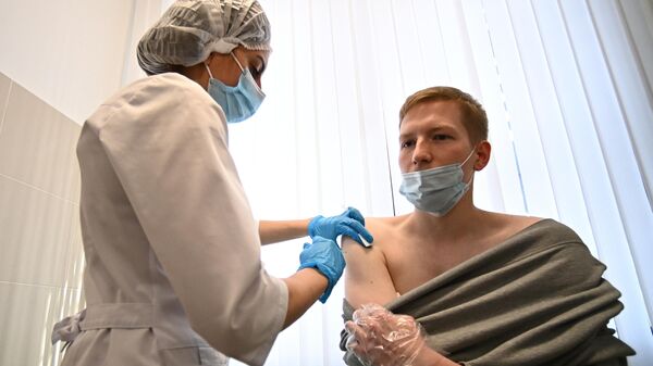 Мужчина во время вакцинации от COVID-19 в центре госуслуг Мои документы в Москве