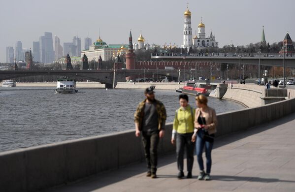 Прохожие на Москворецкой набережной и теплоходы на Москве-реке