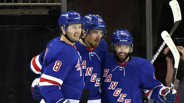 NEW YORK, NEW YORK - APRIL 17: Pavel Buchnevich #89 of the New York Rangers (C) celebrates his 2nd goal of the game at 11:48 of the first period and is joined by Jacob Trouba #8 (L) and Colin Blackwell #43 (R) against the New Jersey Devils at Madison Square Garden on April 17, 2021 in New York City.   Bruce Bennett/Getty Images/AFP (Photo by BRUCE BENNETT / GETTY IMAGES NORTH AMERICA / Getty Images via AFP)