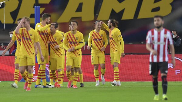 Barcelona's players celebrate after scoring a goal during the Spanish Copa del Rey (King's Cup) final football match between Athletic Club Bilbao and FC Barcelona at La Cartuja stadium in Seville on April 17, 2021. (Photo by CRISTINA QUICLER / AFP)