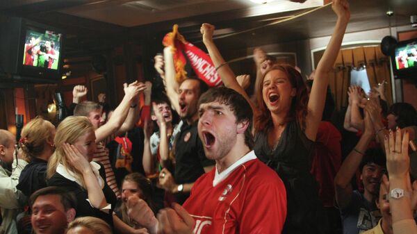 Фанаты Манчестер Юнайтед отмечают титул в московском баре.