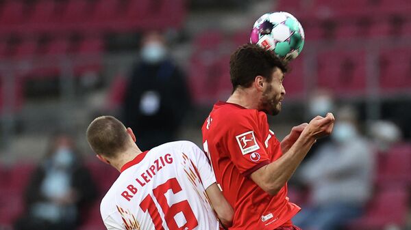 Leipzig's German defender Lukas Klostermann (L0 and Cologne's German defender Jonas Hector vie for the ball during the German first division Bundesliga football match FC Cologne vs RB Leipzig, in Cologne, western Germany, on April 20, 2021. (Photo by Rolf Vennenbernd / POOL / AFP) / DFL REGULATIONS PROHIBIT ANY USE OF PHOTOGRAPHS AS IMAGE SEQUENCES AND/OR QUASI-VIDEO