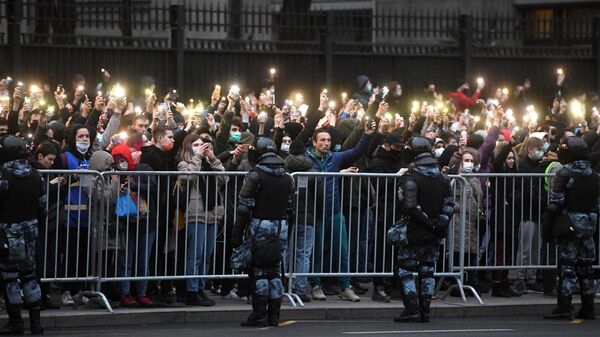 Участники несанкционированной акции в поддержку Алексея Навального держат смартфоны с включенными фонариками в Москве.