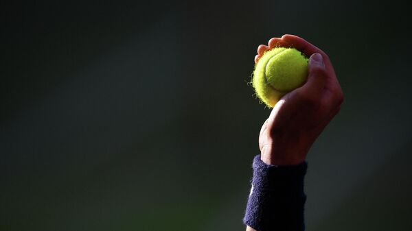 A ballboy holds up a ball as Spain's Rafael Nadal plays Switzerland's Roger Federer during their men's singles semi-final match on day 11 of the 2019 Wimbledon Championships at The All England Lawn Tennis Club in Wimbledon, southwest London, on July 12, 2019. (Photo by Daniel LEAL-OLIVAS / AFP) / RESTRICTED TO EDITORIAL USE