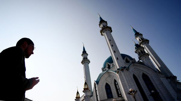 Верующий во время намаза в день праздника Ураза-байрам у мечети Кул-Шариф в Казани