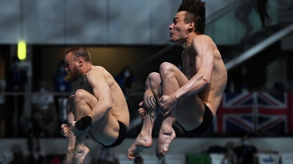Russia's Nikita Shleikher (R) and Russia's Evgenii Kuznetsov compete in the Men's Synchronised 3m Springboard Diving event during the LEN European Aquatics Championships at the Duna Arena in Budapest on May 13, 2021. (Photo by Attila KISBENEDEK / AFP)