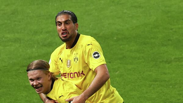 Dortmund's Norwegian forward Erling Braut Haaland celebrates scoring with Dortmund's German midfielder Emre Can during the German Cup (DFB Pokal) final football match RB Leipzig v BVB Borussia Dortmund, in Berlin on May 13, 2021. (Photo by MAJA HITIJ / POOL / AFP) / RESTRICTIONS: ACCORDING TO DFB RULES IMAGE SEQUENCES TO SIMULATE VIDEO IS NOT ALLOWED DURING MATCH TIME. MOBILE (MMS) USE IS NOT ALLOWED DURING AND FOR FURTHER TWO HOURS AFTER THE MATCH. == RESTRICTED TO EDITORIAL USE == FOR MORE INFORMATION CONTACT DFB DIRECTLY AT +49 69 67880 / 