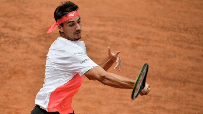 Italy's Lorenzo Sonego returns a forehand to France's Gael Monfils during their first round match of the Men's Italian Open at Foro Italico on May 11, 2021 in Rome, Italy. (Photo by Filippo MONTEFORTE / AFP)