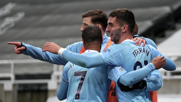 Manchester City's Spanish midfielder Ferran Torres (R) celebrates scoring his team's fourth goal, his third, during the English Premier League football match between Newcastle United and Manchester City at St James' Park in Newcastle-upon-Tyne, north east England on May 14, 2021. (Photo by SCOTT HEPPELL / POOL / AFP) / RESTRICTED TO EDITORIAL USE. No use with unauthorized audio, video, data, fixture lists, club/league logos or 'live' services. Online in-match use limited to 120 images. An additional 40 images may be used in extra time. No video emulation. Social media in-match use limited to 120 images. An additional 40 images may be used in extra time. No use in betting publications, games or single club/league/player publications. / 