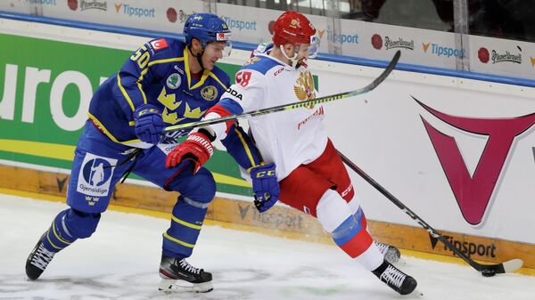 Ice Hockey - Euro Hockey Tour - Carlson Hockey Games - Sweden v Russia - O2 Arena, Prague, Czech Republic - May 12, 2021 Russia's Anton Slepyshev in action with Sweden's Viktor Loov REUTERS/David W Cerny