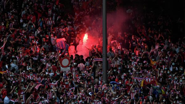 Supporters light flares after Atletico Madrid won the Spanish Liga Championship title on May 22, 2021 in Madrid. - Atletico Madrid were crowned La Liga champions for the first time since 2014 as veteran striker Luis Suarez scored the winner in a 2-1 victory over Valladolid. (Photo by OSCAR DEL POZO / AFP)