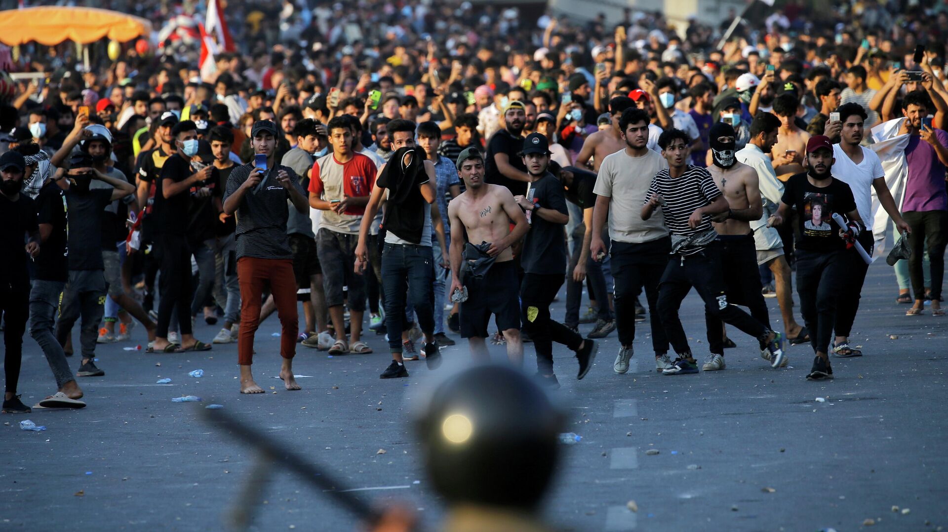 Во время столкновений протестующих с сотрудниками служб безопасности на площади Тахрир в Багдаде, Ирак - РИА Новости, 1920, 25.05.2021