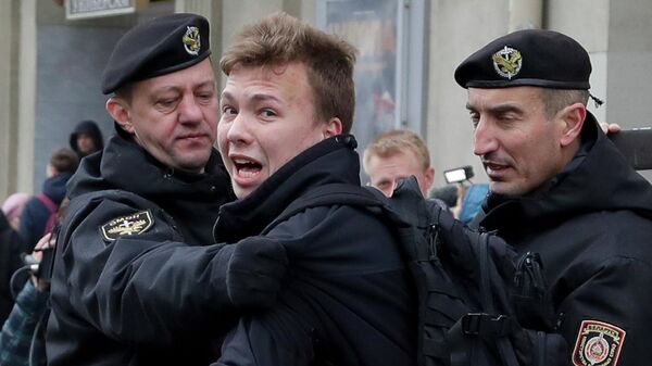 Сотрудники правоохранительных органов Белоруссии задерживают активиста Романа Протасевича во время акции протеста в Минске в 2017 году