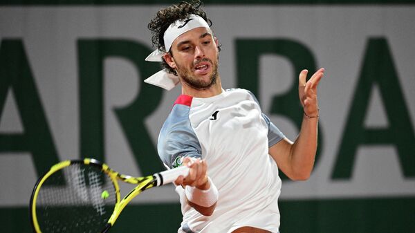 Italy's Marco Cecchinato returns the ball to Germany's Alexander Zverev during their men's singles third round tennis match on Day 6 of The Roland Garros 2020 French Open tennis tournament in Paris on October 2, 2020. (Photo by MARTIN BUREAU / AFP)