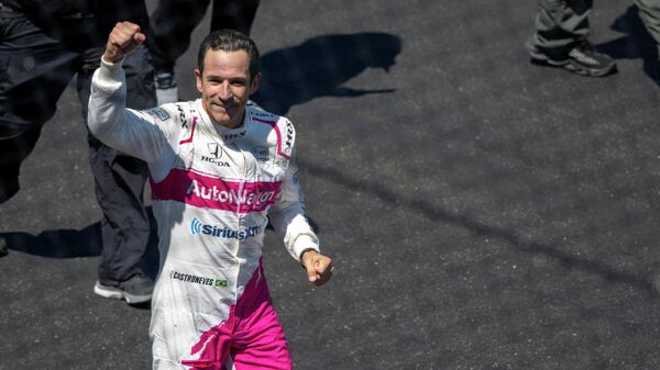 May 30, 2021; Indianapolis, Indiana, USA; Meyer Shank Racing driver Helio Castroneves (6) puts his fist toward the crowd after winning the 105th running of the Indianapolis 500 at Indianapolis Motor Speedway. Mandatory Credit: Marc Lebryk-USA TODAY Sports