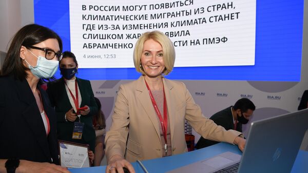 Заместитель председателя правительства РФ Виктория Абрамченко выпускает новость на сайт ria.ru на стенде МИА Россия сегодня на Петербургском международном экономическом форуме - 2021