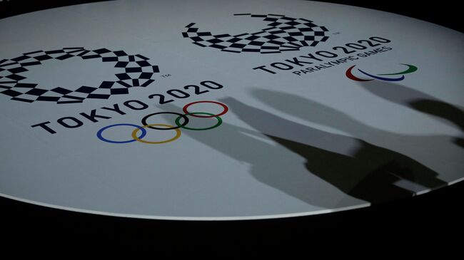 The emblems of the Tokyo 2020 Olympic and Paralympic Games are displayed during an event to unveil the medals, podium and music to be used for the medal ceremonies at the Tokyo 2020 Olympics Games at Ariake Arena in Tokyo on June 3, 2021. (Photo by ISSEI KATO / POOL / AFP)