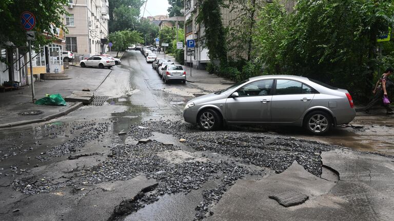 Размытое дорожное покрытие в результате сильного ливня в Ростове-на-Дону